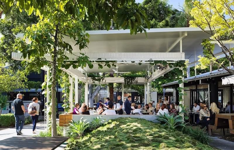 Shopping strip with greenery and covered outdoor seating